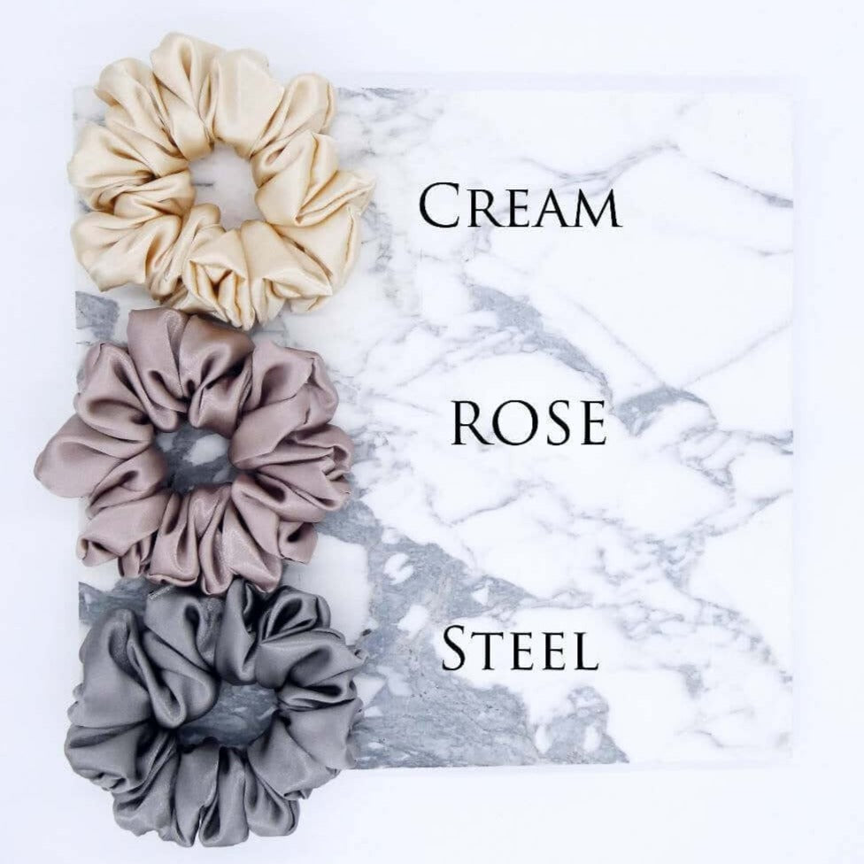 Three luxury large satin hair scrunchies in cream, rose and slate.