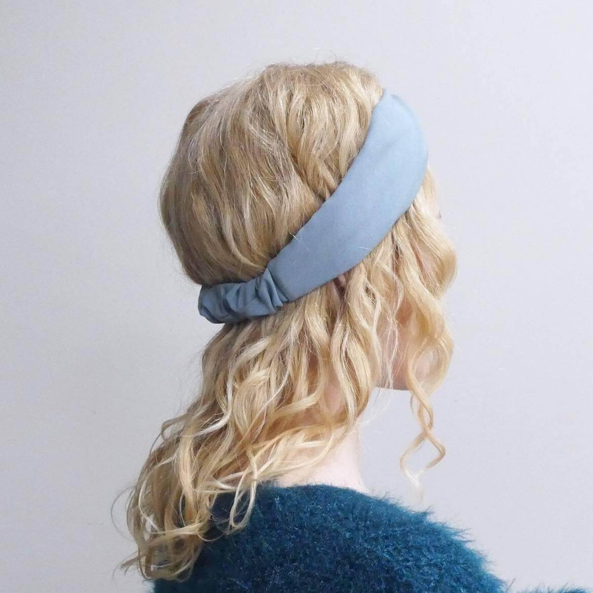 Model wears a soft, pale blue, viscose, elasticated turban twist headband.