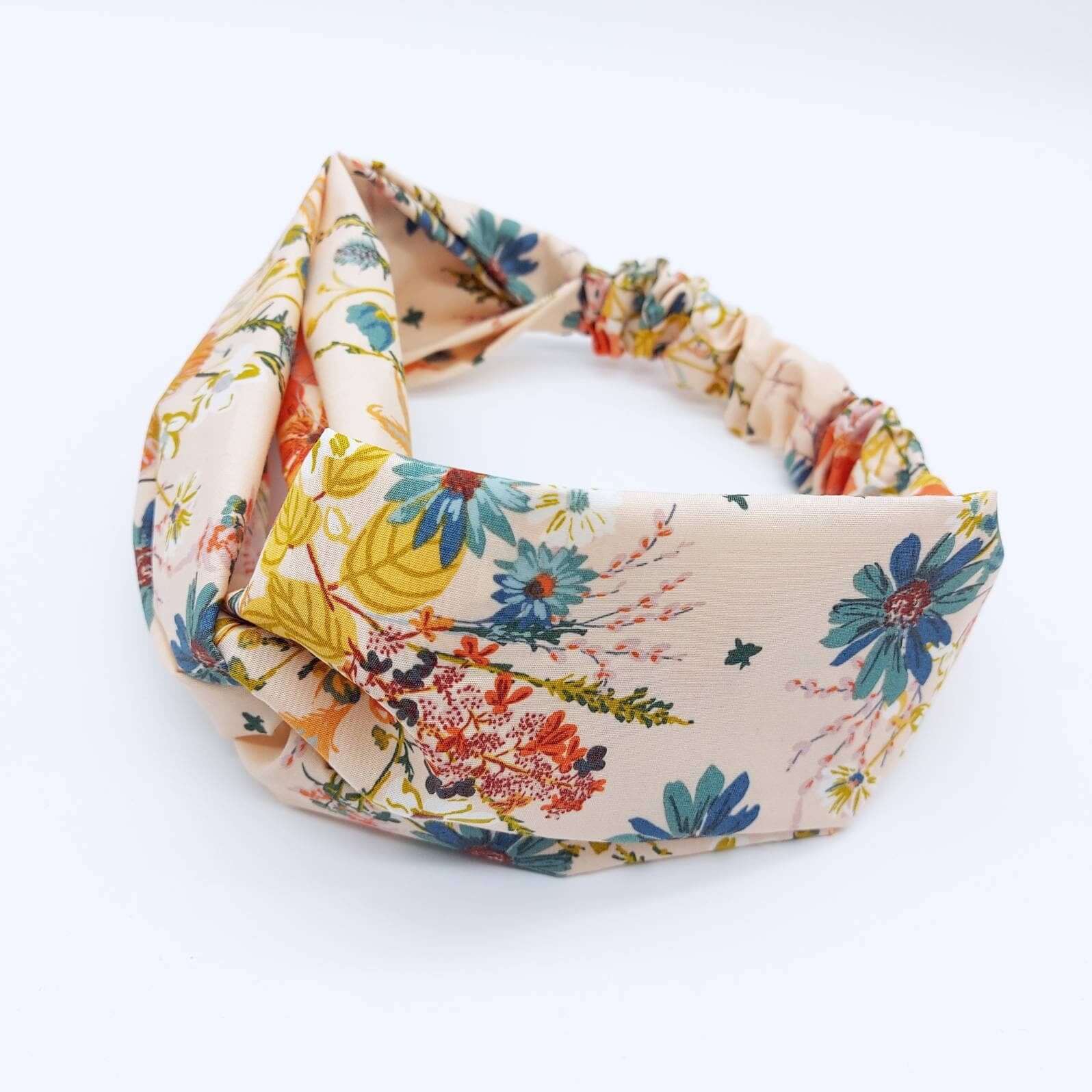 A pretty cream cotton, floral print turban twist headband with an elasticated panel at the back.