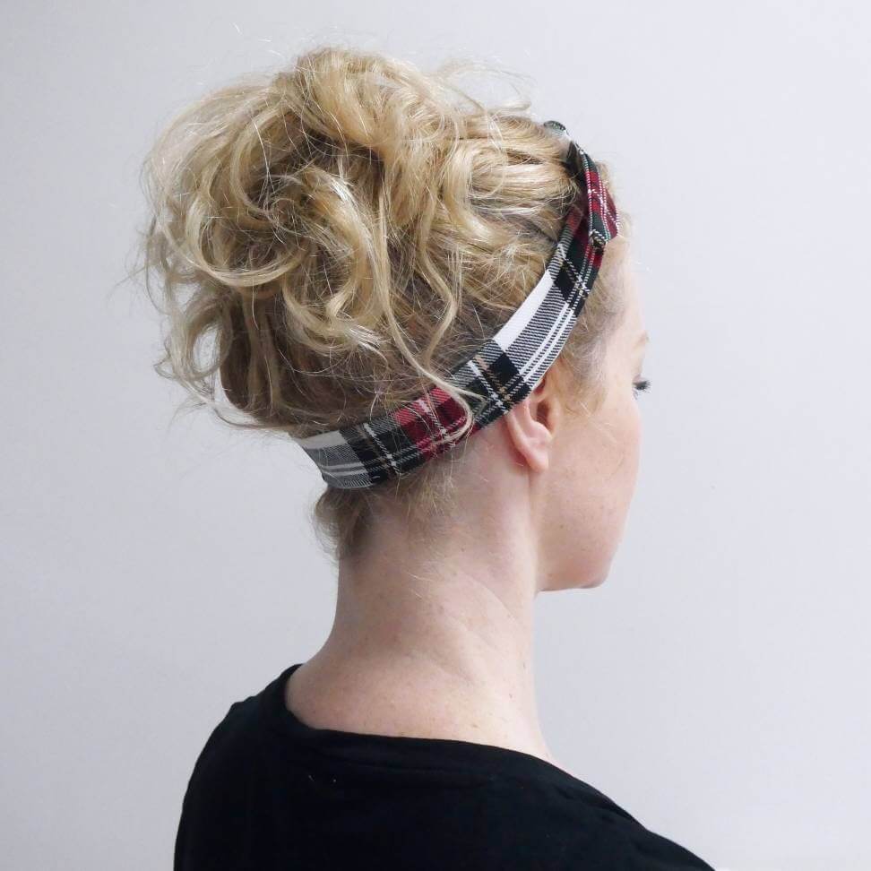 Model wears a soft, red and white tartan check fabric, tie headband, tied in a pretty knot.