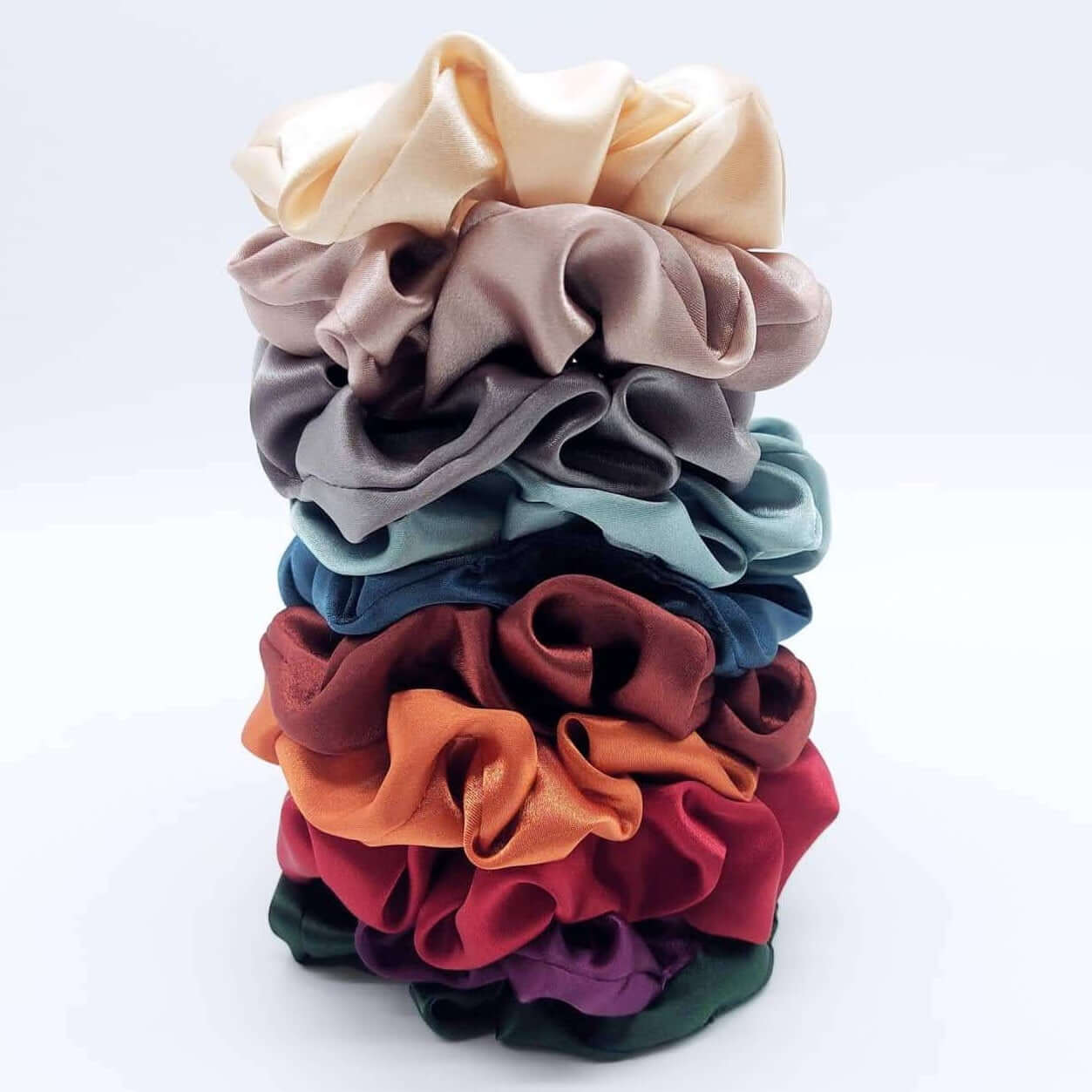 A rainbow tower of luxury satin scrunchies.