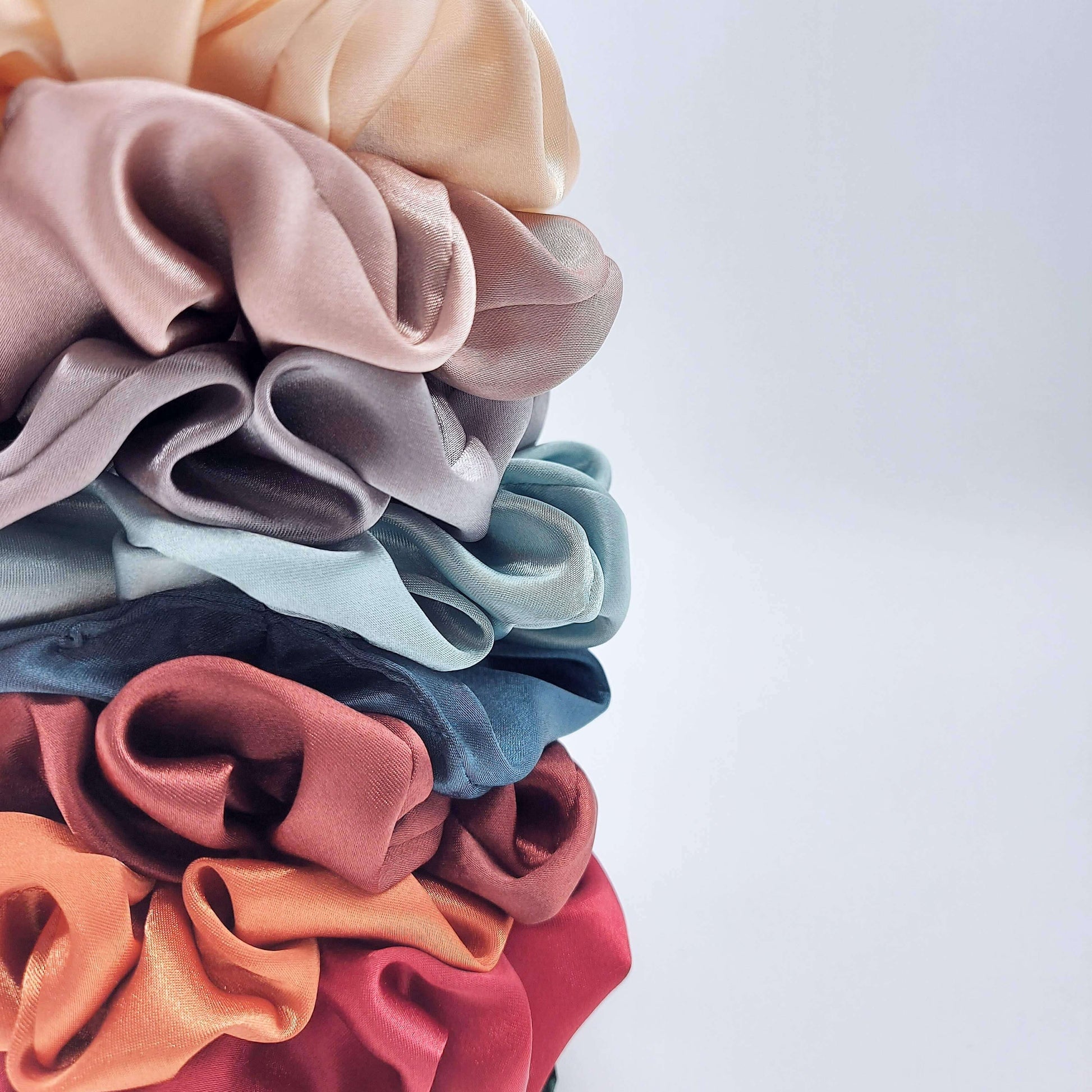 A rainbow tower of luxury satin scrunchies.
