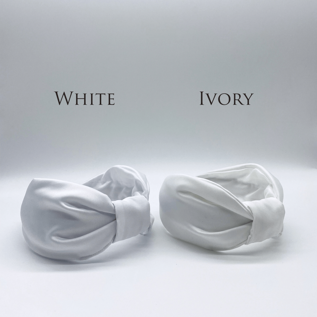 Two satin knot headbands in white and ivory.