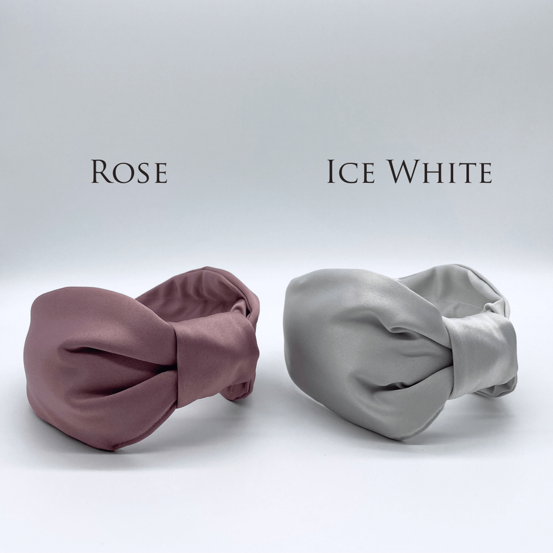 Two satin knot headbands in rose pink and ice white.