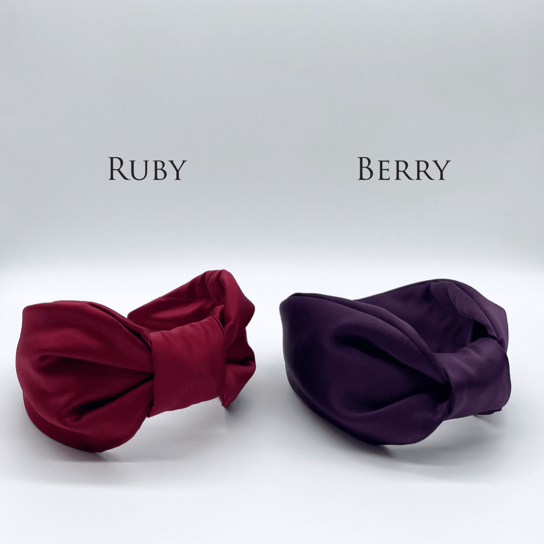 Two satin knot headbands in ruby red and berry purple.