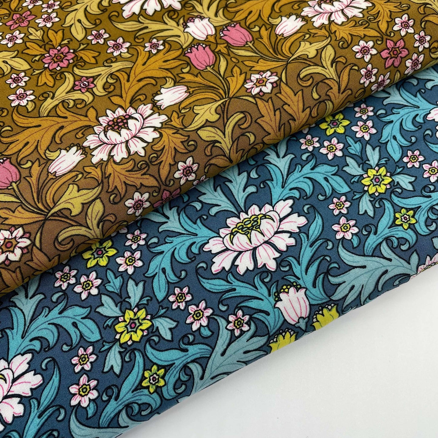 William Morris-style fabrics, one in yellow and one in blue. Flowers and leaves print