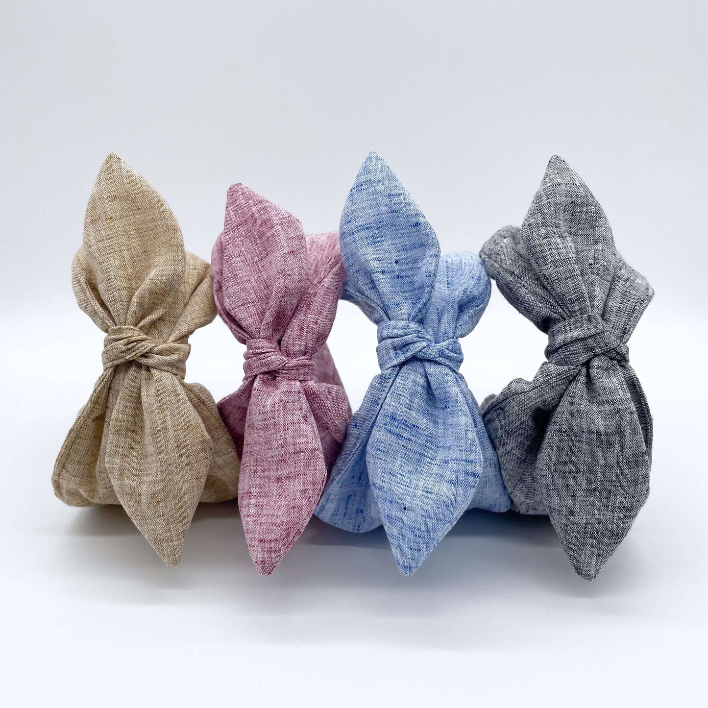 Four pretty linen fabric headbands with bows, pink, natural, blue and black.