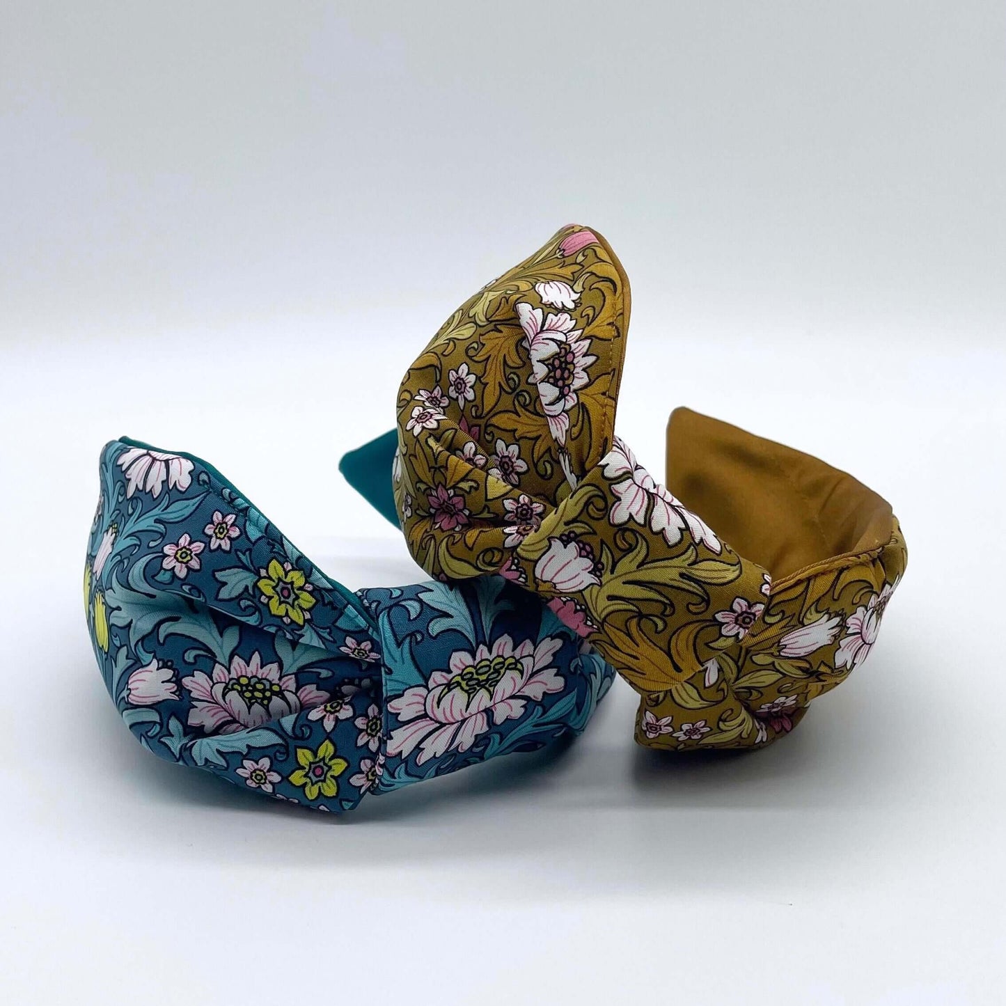 Two William Morris- Inspired Knot Headbands with satin lining in blue and mustard. Flowers and leaves print