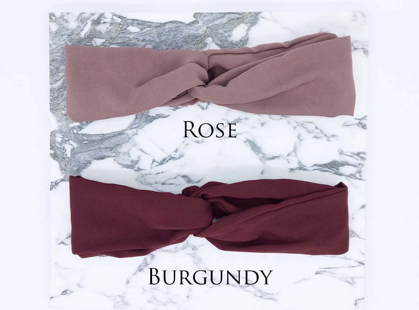 Two soft, viscose, elasticated turban twist headbands in rose pink and burgundy.