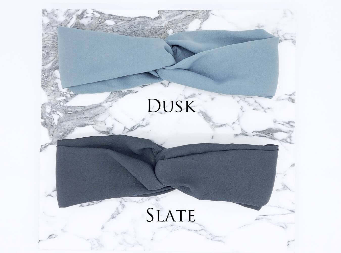 Two soft, viscose, elasticated turban twist headbands in pale blue and slate grey.