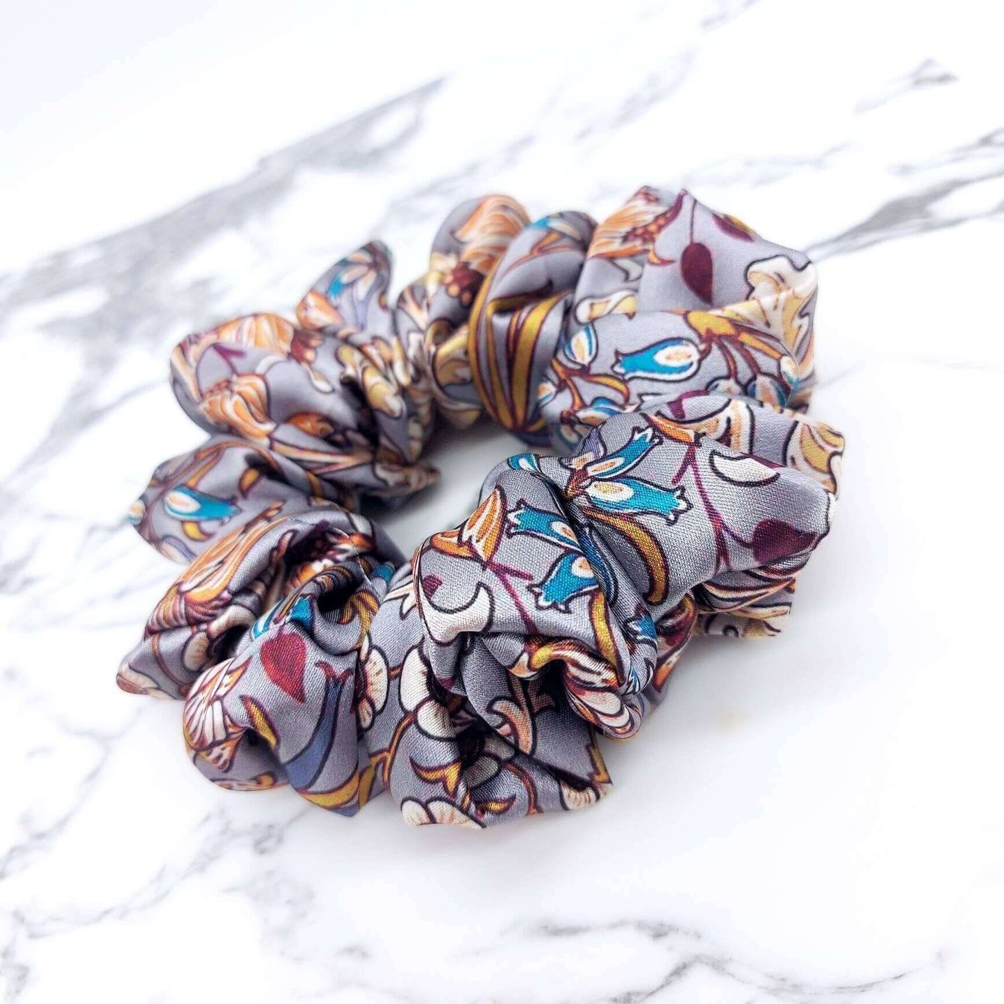 A beautiful grey, William Morris-inspired, patterned satin scrunchie with lots of ruffles.