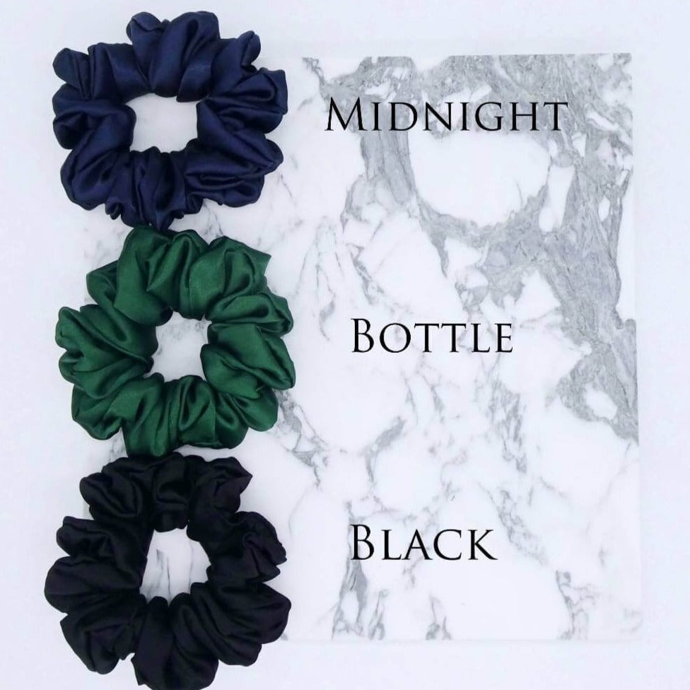 Three luxury large satin hair scrunchies in midnight blue, bottle and black.