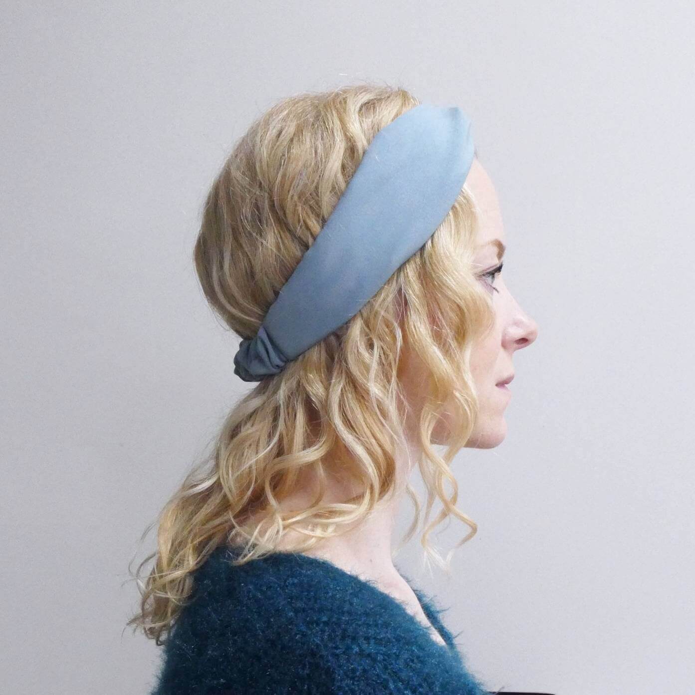 Model wears a soft, pale blue, viscose, elasticated turban twist headband.
