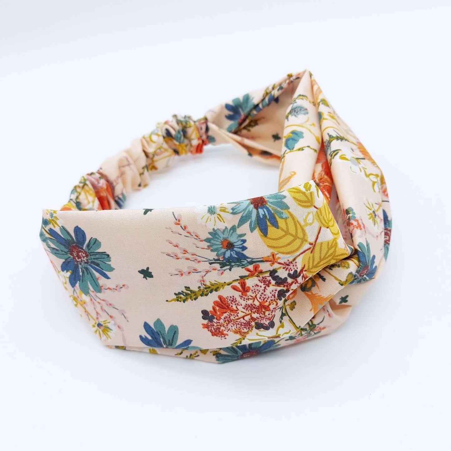 A pretty cream cotton, floral print turban twist headband with an elasticated panel at the back.