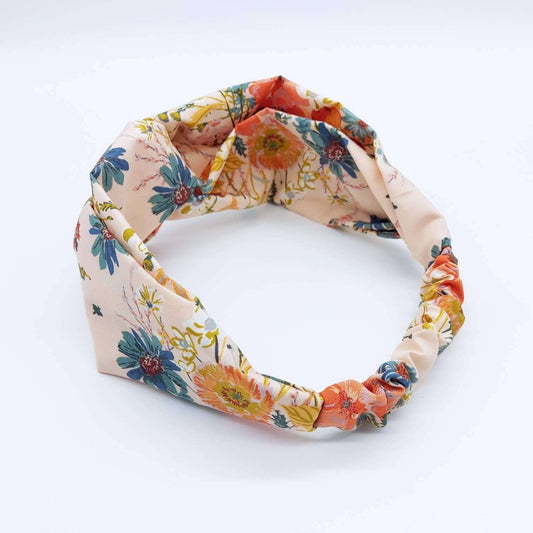 A pretty cream cotton, floral print turban twist headband with an elasticated panel at the back.