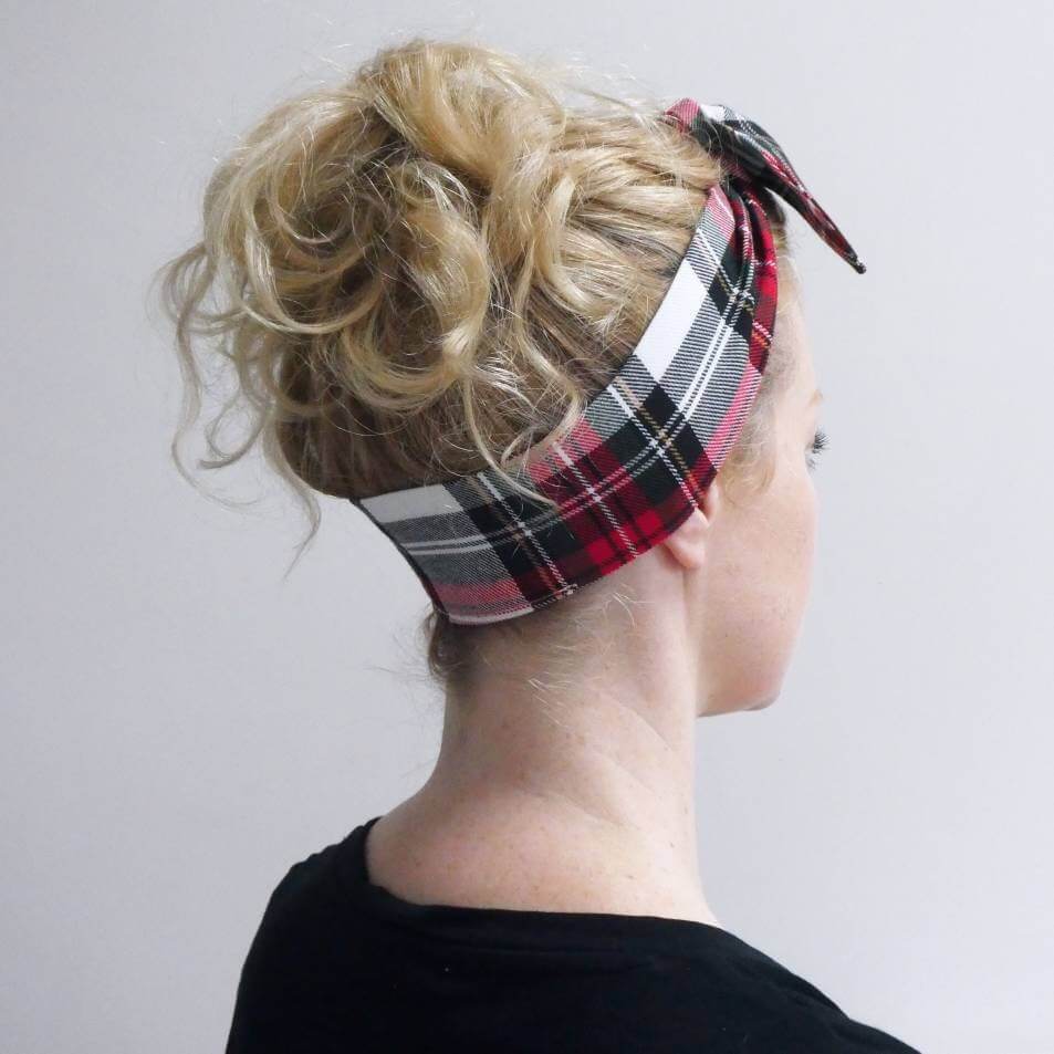 Model wears a soft, red and white tartan check fabric, tie headband, tied in a pretty knot.