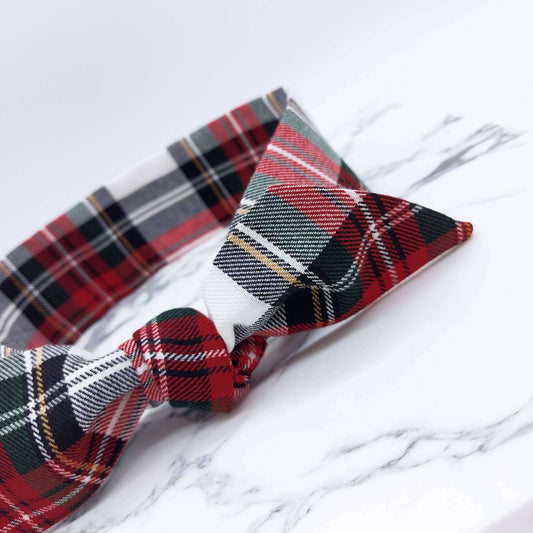 A soft, red and white tartan check fabric, tie headband, tied in a pretty knot.