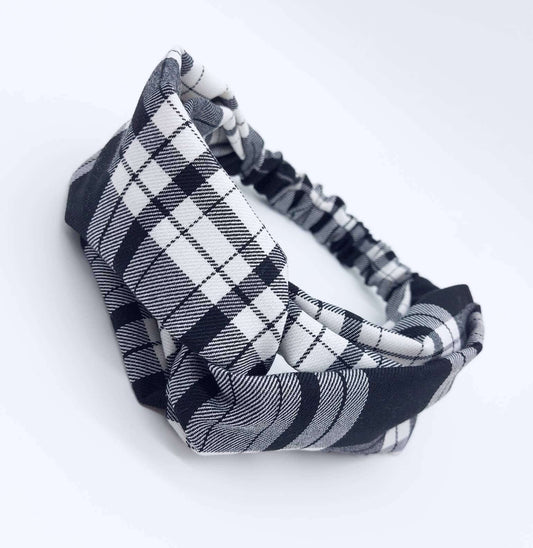 A soft, black and white tartan plaid check, turban twist headband with an elasticated panel at the back.