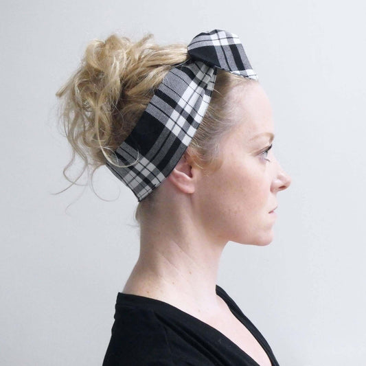 Model wears a tartan plaid, monochrome, black and white fabric, tie headband, tied in a pretty knot.