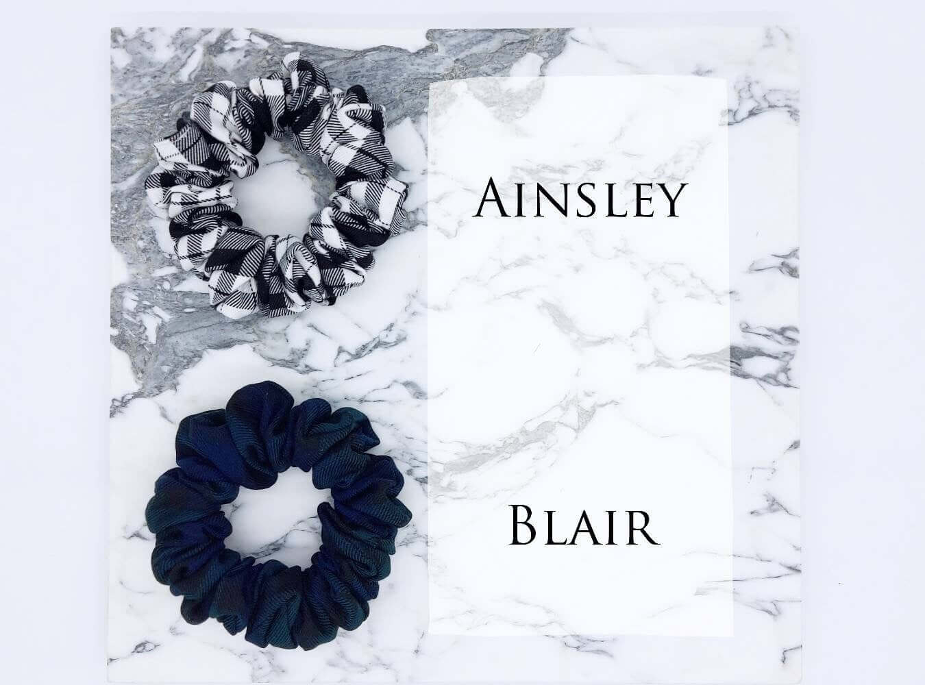 Two luxury tartan check hair scrunchies, one black and white and one green and navy.