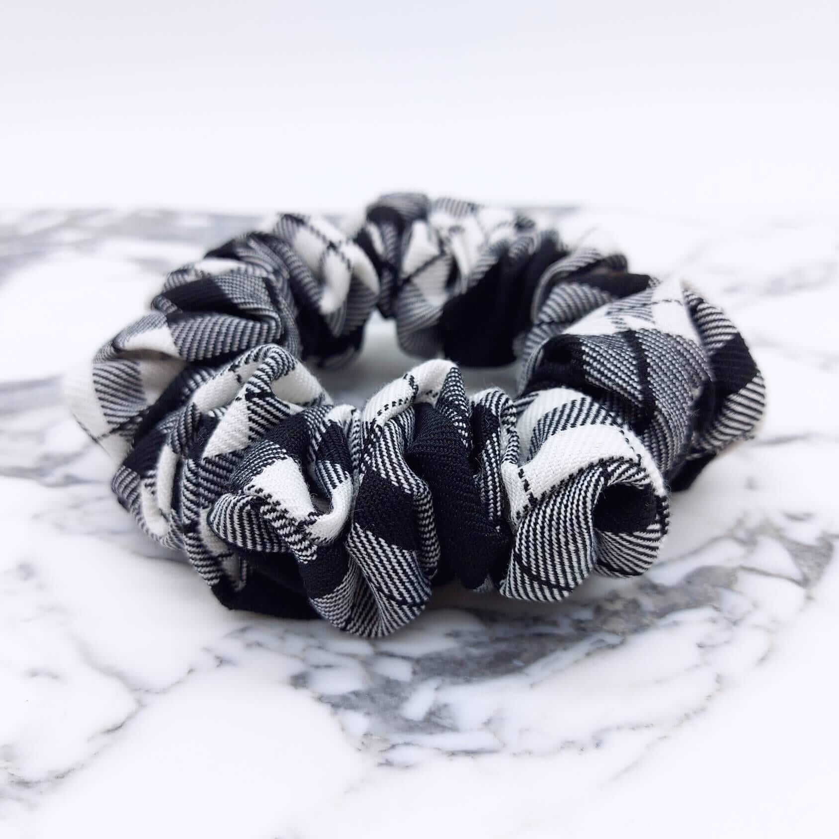 A luxury tartan check, black and white, monochrome hair scrunchie.
