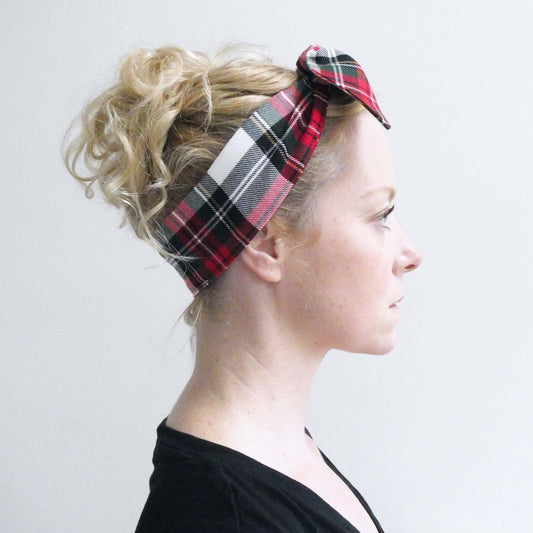 Model wears a soft, red and white tartan check fabric, tie headband, tied in a pretty knot.