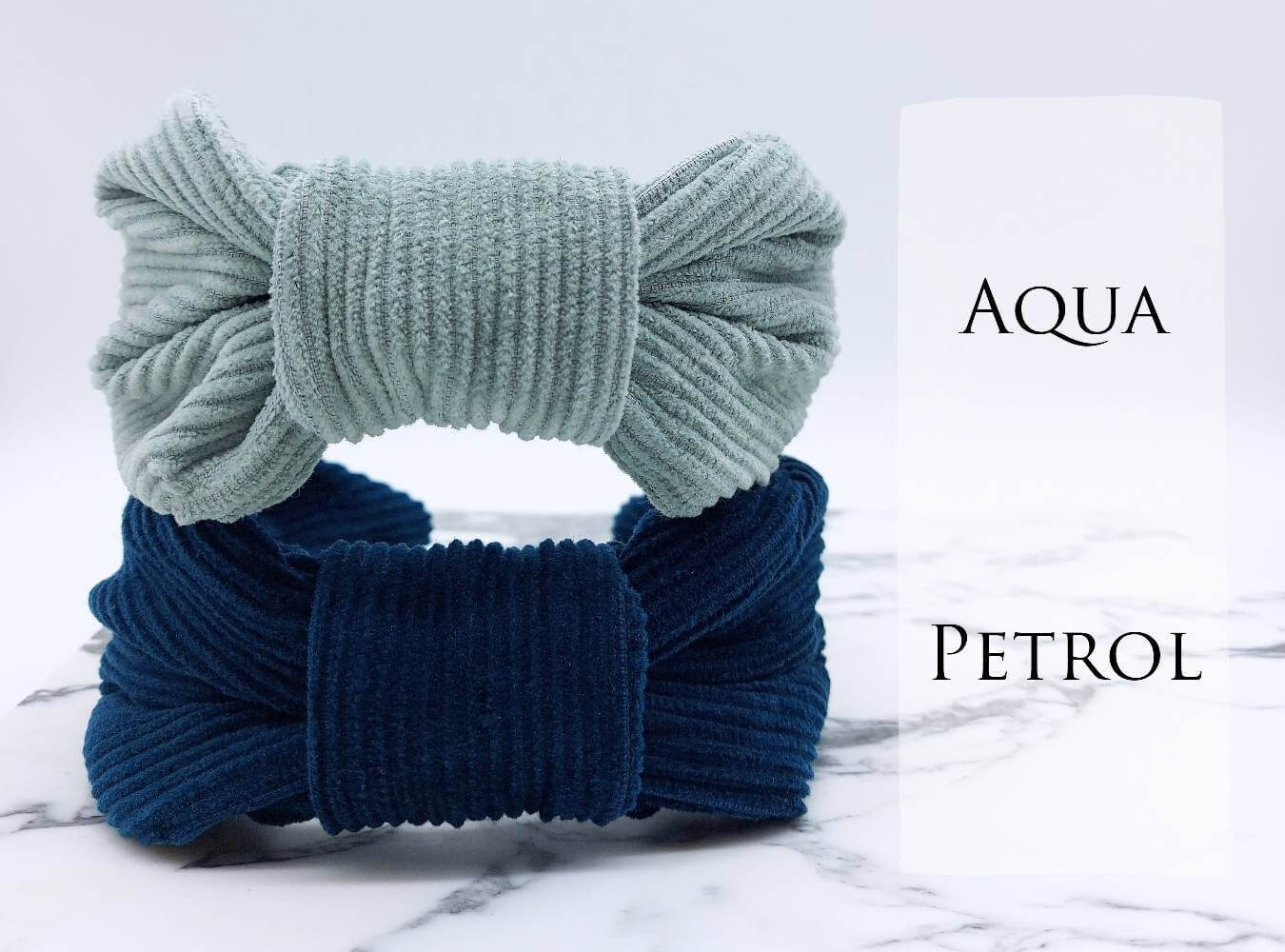 Two, luxury bow-style, corduroy fabric knot headbands in pale blue and petrol blue.