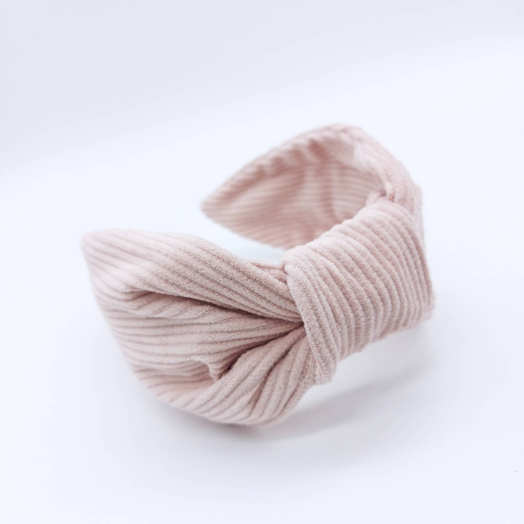 A luxury bow-style, pale pink-coloured thick corduroy fabric knot headband.