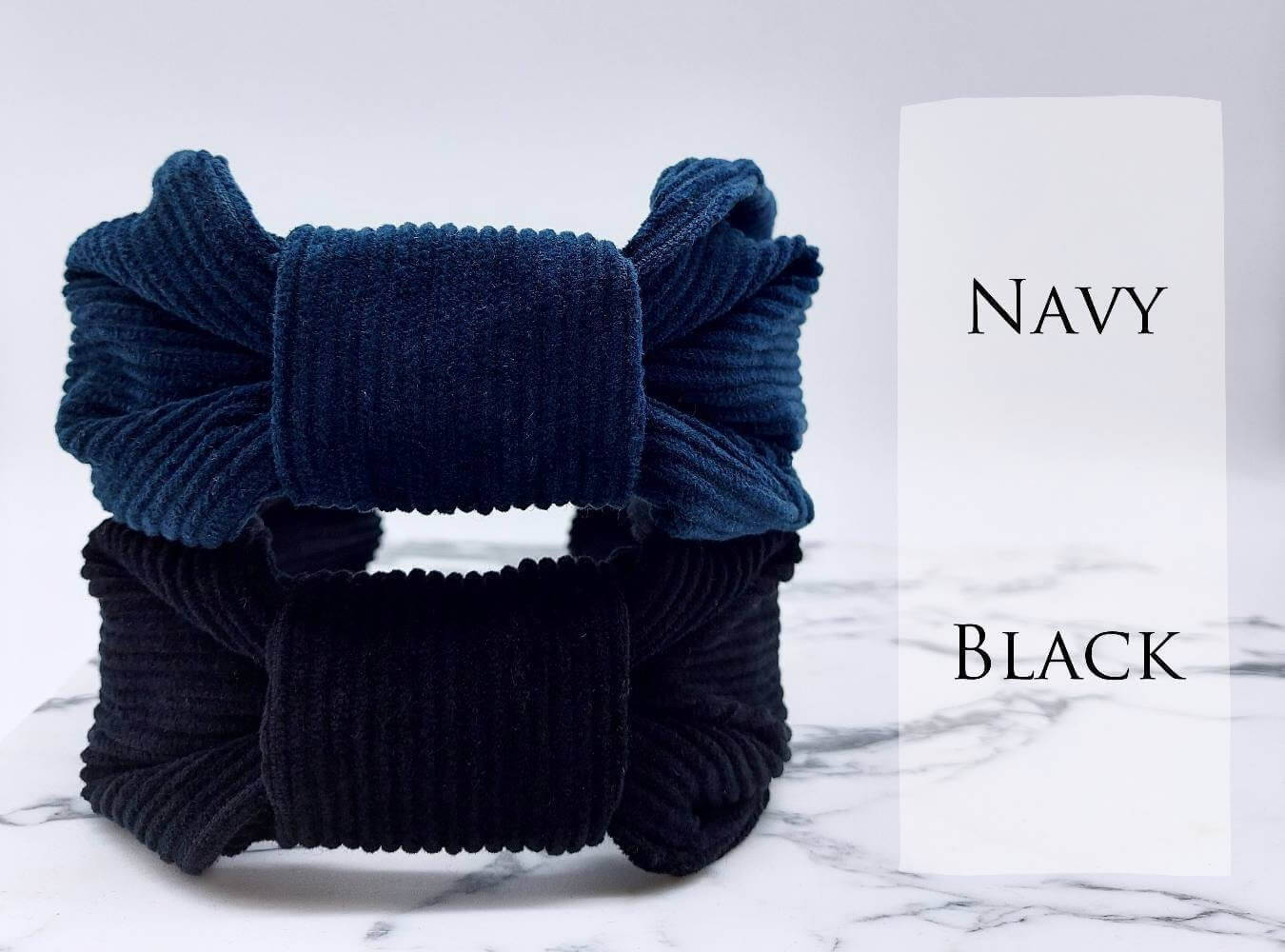 Two, luxury bow-style, corduroy fabric knot headbands in  navy blue and black.