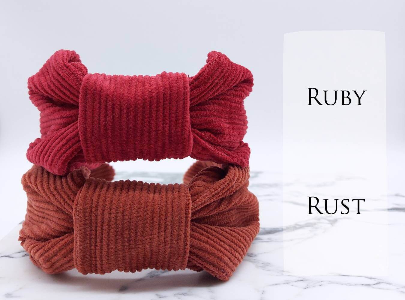 Two, luxury bow-style, corduroy fabric knot headbands in  red and rust.