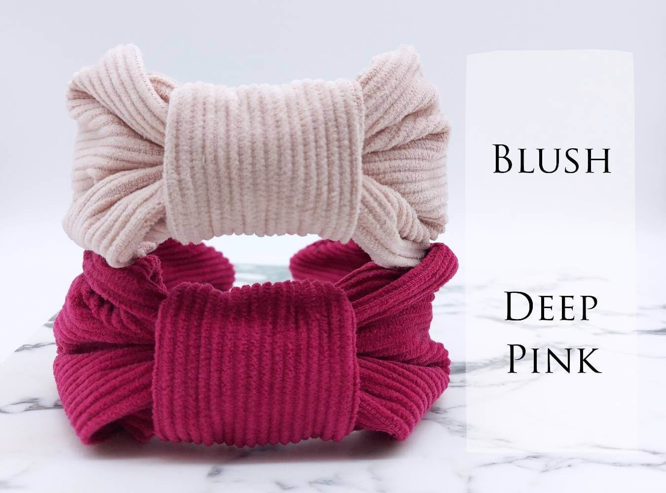 Two, luxury bow-style, corduroy fabric knot headbands in pale pink and dark pink.